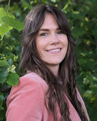 Portrait of Jessica Vining, Registered Psychotherapist, smiling warmly in professional attire